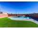 Modern kidney-shaped pool with water feature at 3556 Valley Lily St, North Las Vegas, NV 89032