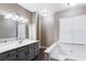 Bathroom with double vanity and soaking tub at 3971 Foxboro Cir, Las Vegas, NV 89121