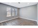 Bright bedroom with wood-look floors and large windows at 3971 Foxboro Cir, Las Vegas, NV 89121