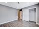Bedroom with wood-look floors, closet, and door to hallway at 3971 Foxboro Cir, Las Vegas, NV 89121