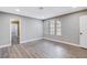 Bright bedroom with wood-look floors and access to hallway at 3971 Foxboro Cir, Las Vegas, NV 89121