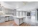 Open concept kitchen with island, stainless steel appliances, and views to living room at 3971 Foxboro Cir, Las Vegas, NV 89121