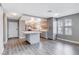Gray kitchen cabinets, white countertop island, and wood flooring at 3971 Foxboro Cir, Las Vegas, NV 89121