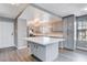 Modern kitchen with gray cabinets, white quartz island, and luxury vinyl flooring at 3971 Foxboro Cir, Las Vegas, NV 89121