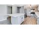 Kitchen with gray cabinets, white island, and wood-look flooring at 3971 Foxboro Cir, Las Vegas, NV 89121