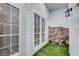 Private patio with artificial turf and stone wall at 3971 Foxboro Cir, Las Vegas, NV 89121