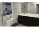 Bathroom featuring double sinks, a soaking tub, and a separate glass-enclosed shower at 4372 Panoramic View Ave, North Las Vegas, NV 89084