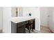 Bathroom vanity featuring a gray cabinet, white countertop and framed mirror at 4372 Panoramic View Ave, North Las Vegas, NV 89084