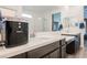 Bathroom featuring double sinks, sleek countertops, vanity, large mirrors, and a glass-enclosed shower at 4372 Panoramic View Ave, North Las Vegas, NV 89084