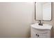 Simple, clean bathroom with white vanity and small mirror at 618 Lava Beds Way, North Las Vegas, NV 89084