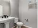 Small bathroom with pedestal sink and toilet at 6440 Bright Morning St, North Las Vegas, NV 89084