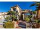 Two story house exterior with stone accents, palm trees and landscaping at 6440 Bright Morning St, North Las Vegas, NV 89084