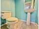 Small bathroom with pedestal sink and tile floors at 7632 Highland Pony St, Las Vegas, NV 89149