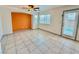 Gathering room with orange accent wall and door to patio at 7632 Highland Pony St, Las Vegas, NV 89149