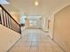 Living room with tile floors and staircase at 7632 Highland Pony St, Las Vegas, NV 89149