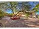 Large backyard with patio, tree, and seating area at 7779 Parnell Ave, Las Vegas, NV 89147