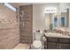 Bathroom with wood-look tile shower and granite vanity at 7779 Parnell Ave, Las Vegas, NV 89147