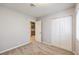 Bright bedroom with double door closet and view of kitchen at 7779 Parnell Ave, Las Vegas, NV 89147