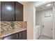 Laundry room with washer, dryer and dark wood cabinets at 7779 Parnell Ave, Las Vegas, NV 89147