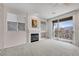 Bright living room featuring a fireplace, plush carpet, and a sliding glass door to a private balcony at 805 Dana Hills Ct # 104, Las Vegas, NV 89134