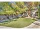 Landscaped side yard with a grassy area and mature trees at 8170 W Red Coach Ave, Las Vegas, NV 89129