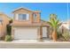 Two-story house with a beige exterior, white garage door, and landscaping at 886 Park Walk Ave, Las Vegas, NV 89123