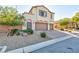 Two-story house with a three-car garage and drought-tolerant landscaping at 9085 Bridal Creek Ave, Las Vegas, NV 89178