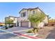 Two-story house with a three-car garage and landscaped front yard at 9085 Bridal Creek Ave, Las Vegas, NV 89178