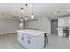 Spacious kitchen island with white cabinets and quartz countertop at 9085 Bridal Creek Ave, Las Vegas, NV 89178