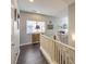 Upstairs hallway with dark hardwood floors and white railings at 9113 Sea Mink Ave, Las Vegas, NV 89149