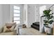 Light and airy entryway with modern seating, a large plant, and stairs at 92 Kimberlite Dr, Henderson, NV 89011