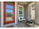 Inviting front porch with red door, sitting area, and fire pit at 92 Kimberlite Dr, Henderson, NV 89011