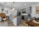 Spacious kitchen featuring gray cabinets, granite counters, and stainless steel appliances at 92 Kimberlite Dr, Henderson, NV 89011