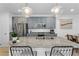 Modern kitchen featuring gray cabinets, granite countertops, and stainless steel appliances at 92 Kimberlite Dr, Henderson, NV 89011