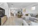 Open concept living room and kitchen with light flooring and neutral decor at 92 Kimberlite Dr, Henderson, NV 89011
