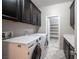 Laundry room with washer, dryer, cabinets, and extra shelving at 12461 Mosticone Way, Las Vegas, NV 89141