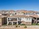 Home with backyard patio, mountain views, and two-story design at 1319 Red Baron Ln, Boulder City, NV 89005