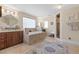 Spa-like bathroom with double vanities, soaking tub, and walk-in shower at 1319 Red Baron Ln, Boulder City, NV 89005