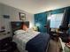 Cozy bedroom with teal walls, a wooden headboard, and a comfortable-looking bed at 1414 N Jones Blvd, Las Vegas, NV 89108