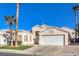 House exterior featuring a white garage door and palm trees at 1570 Raining Hills St, Henderson, NV 89052