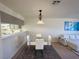 Dining area with glass table and four white chairs at 2036 Mesquite Ln # 303, Laughlin, NV 89029