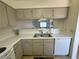 Kitchen features taupe cabinets, white appliances, and double sink at 2036 Mesquite Ln # 303, Laughlin, NV 89029