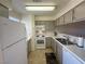 White appliances and light taupe cabinets in this galley kitchen at 2036 Mesquite Ln # 303, Laughlin, NV 89029