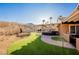 Landscaped backyard oasis with covered patio and artificial turf at 2149 Cedar River Ct, Henderson, NV 89044