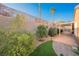 Landscaped backyard with patio, trees, and a stone pathway at 2149 Cedar River Ct, Henderson, NV 89044