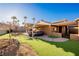 Spacious backyard with covered patio, artificial turf, and mountain views at 2149 Cedar River Ct, Henderson, NV 89044