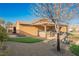 Landscaped backyard with covered patio and outdoor kitchen at 2149 Cedar River Ct, Henderson, NV 89044