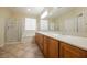 Bathroom boasts double sinks, large mirror, and bathtub at 2149 Cedar River Ct, Henderson, NV 89044