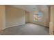 Simple carpeted bedroom with large window and neutral walls at 2149 Cedar River Ct, Henderson, NV 89044