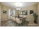 Virtually staged dining room with a modern table and chairs at 2149 Cedar River Ct, Henderson, NV 89044